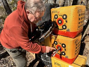 crossbow test team assessing arrow grouping